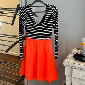 Open back hot orange and black and white sleeves dress. Very different and edgy.